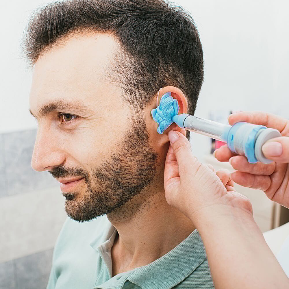 custom earplug being molded